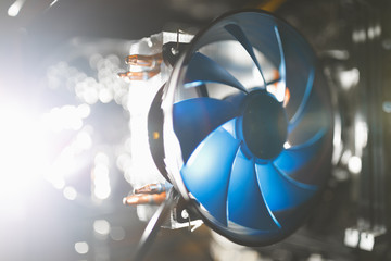 blue cpu cooler inside PC case, shiny light background