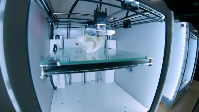 Modern 3D printer printing figure close-up macro.Automatic three dimensional 3d printer performs plastic white color modeling in laboratory. 3d-printing processing with white background