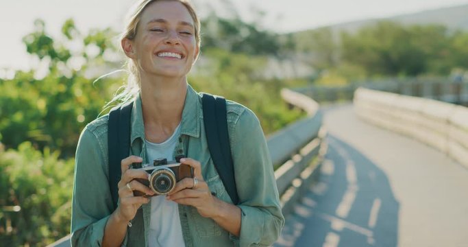 Young attractive traveler woman smiling and laughing taking photographs of beautiful outdoor scenes, young woman exploring with her camera