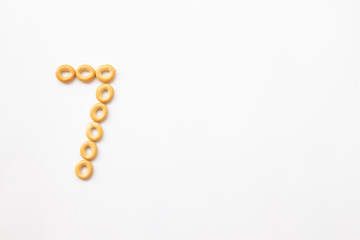number 7 made from cookies on a white background with space for text. layout for school or diet