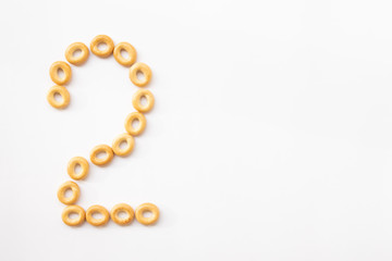 number 2 made from cookies on a white background with space for text. layout for school or diet
