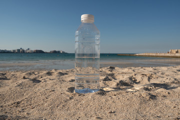 Closeup to bottle of water on the beach