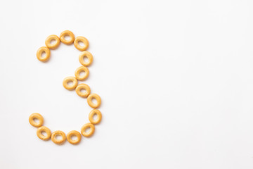 Obraz premium number 3 made from cookies on a white background with space for text. layout for school or diet