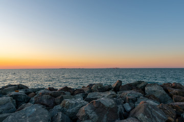 Fototapeta na wymiar Sunset at the rocky beach shot at summer evening 