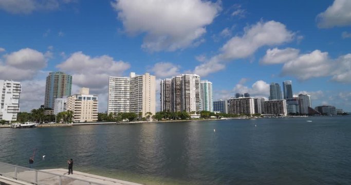 A slow motion tracking shot of typical Miami apartment or condominium buildings on a sunny summer day.  	