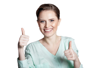 Obraz premium Happy young woman shows thumbs up isolated on white background