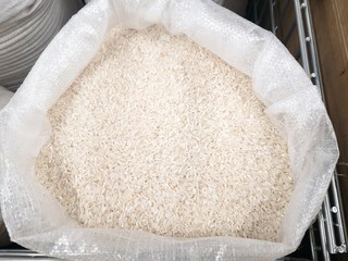 White rise in the sack with selective focus. Rice background. Uncooked rice for healthy dietary dishes. 