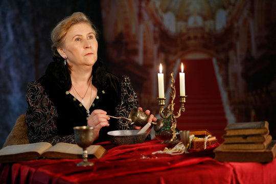 The medieval queen. A woman in the image of Bon Sforza. Medieval woman in a medieval castle. Evil witch