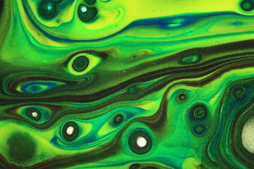 Neon yellow and green contrast with black in this swirling abstract background. - obrazy, fototapety, plakaty