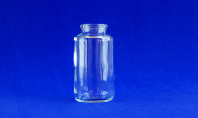 Glass bottle for medicines. .Container for liquid and dry medicines without a cap on a white background. Empty transparent jar for pills and vitamins.