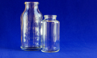 Glass bottles for medicines. .Container for liquid and dry medicines without a cap on a white background. Empty transparent jar for pills and vitamins.