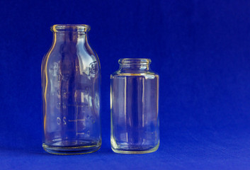 Glass bottles for medicines. .Container for liquid and dry medicines without a cap on a white background. Empty transparent jar for pills and vitamins.
