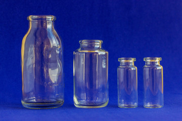 Glass bottles for medicines. .Container for liquid and dry medicines without a cap on a white background. Empty transparent jar for pills and vitamins.