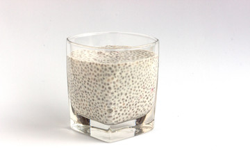 Healthy dessert pudding with chia seeds in a glass cup on a white background.  Diet food and weight loss concept.  Minimal design