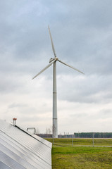 Renewable alternative clean wind energy produced by wind generators helps to preserve The earth's ecology. - 311619239