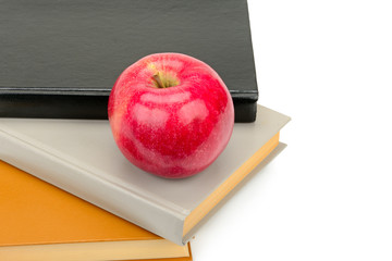 Books and apple isolated on white background. Free space for text.