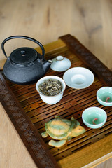 Obraz na płótnie Canvas Tea ceremony process set for tea ceremony on a tea board with white Chinese tea.