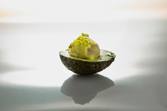 half of the avocado on a bright background