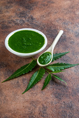 Medicinal Neem leaves with paste on stone background