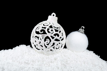 Christmas balls in snow on a black background