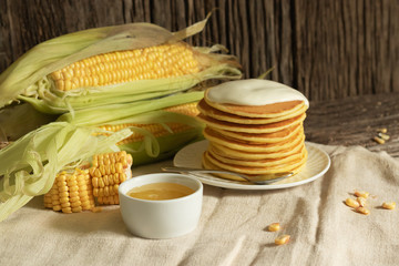 American pancake with cream on a rustic wooden background. Minimal style in natural colors. Diet menu and vegetarian dish.