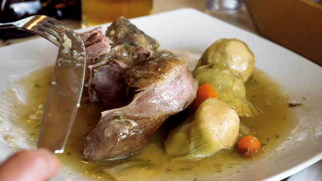 Greek food. Close-up of baked lamb with vegetables on a white plate. Greece. 4K