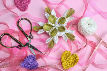 Japanese kanzashi, handmade flowers, hearts, ribbon on pink background