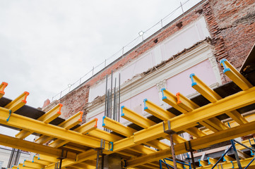 Fototapeta premium Yellow wooden beams for monolithic building construction