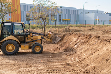Fototapeta na wymiar the excavator bulldozer machine working to build the new apartment complex