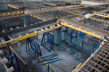 Yellow wooden beams for monolithic building construction