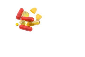 A pile of multi-colored pills, vitamin and tablets isolated on white background