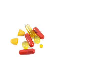 A pile of multi-colored pills, vitamin and tablets isolated on white background