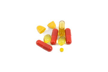 A pile of multi-colored pills, vitamin and tablets isolated on white background