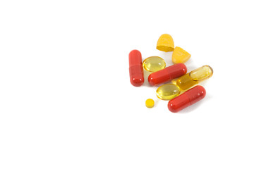 A pile of multi-colored pills, vitamin and tablets isolated on white background