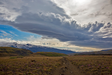 Beautiful clouds over the hilly landscapes of Iceland. Nature and places for wonderful travels