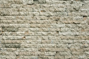 Old gray brick wall of hewn stone.