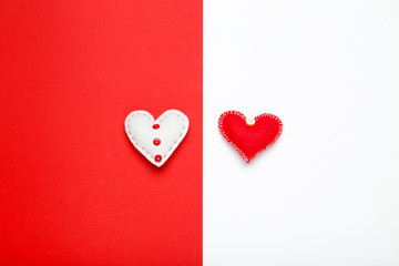 Fabric hearts on colorful paper background