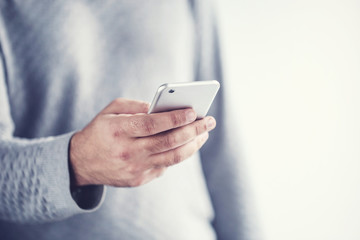 Man holding and using mobile phone