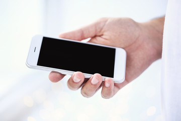 Man holding and using mobile phone