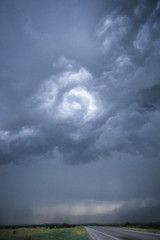 Obraz na płótnie Canvas Rotating clouds of a thunderstorm above the road