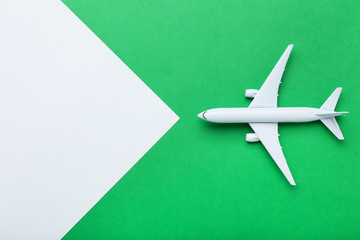 Airplane model on green paper background