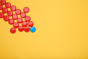 Bottle caps leader on yellow background