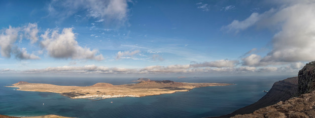 Fototapeta na wymiar Aerial view of La Graciosa Island from Lanzarote against a dramatic sky, Canary Islands, Spain