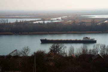 The ship is floating on the river.