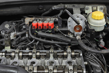 LPG converted  car engine, camshafts  at cylinder head with regulator and evaporator of LPG system