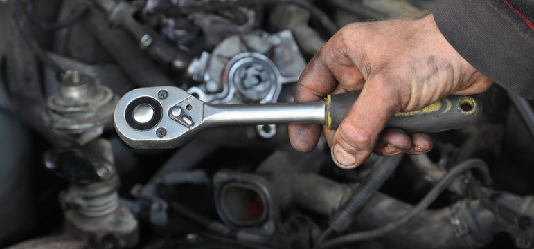 Socket wrench tool in mechanic hand