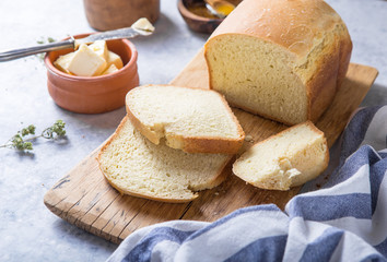 Fresh homemade crisp bread  and slices with olive oil, butter and green olives, top view.  Baking concept