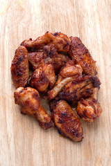 Fried wings close-up. Buffalo wings on a wooden board.