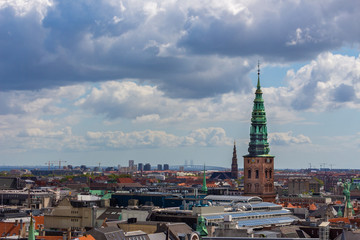 Copenhagen skyline. Denmark capital city streets and danish house roofs. Copenhagen old town and copper spiel of Nikolaj Church panoramic view from top.