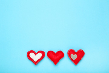 Fabric hearts on blue background